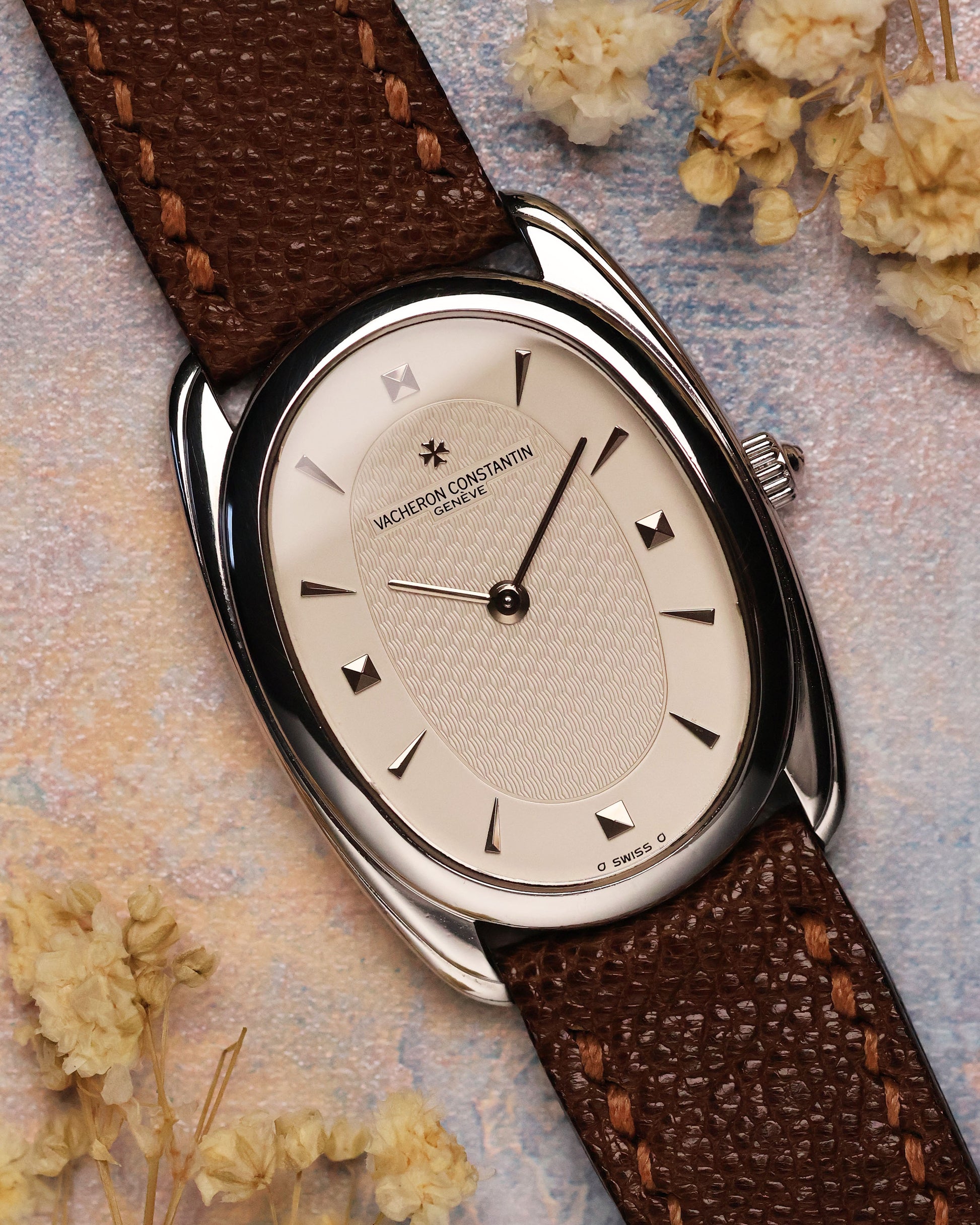 Vacheron Constantin Historiques 31110 in platinum – close-up of guilloché silver dial with applied pyramid and baton markers, showing the elongated oval case and brown textured leather strap.