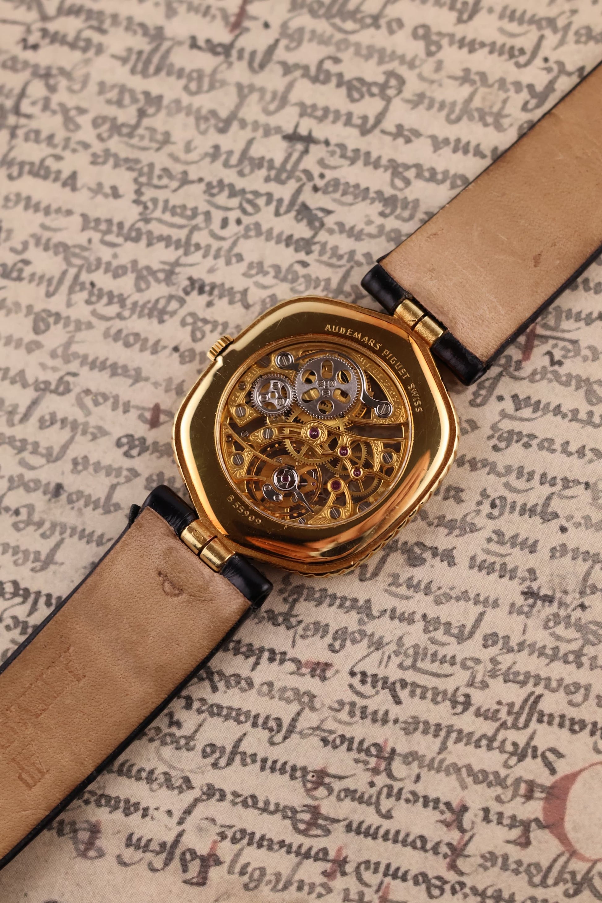 Rear view of Audemars Piguet skeleton watch with sapphire case back revealing engraved movement architecture
