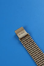 Close-up of Audemars Piguet Bamboo bracelet with alternating smooth and textured gold finishe