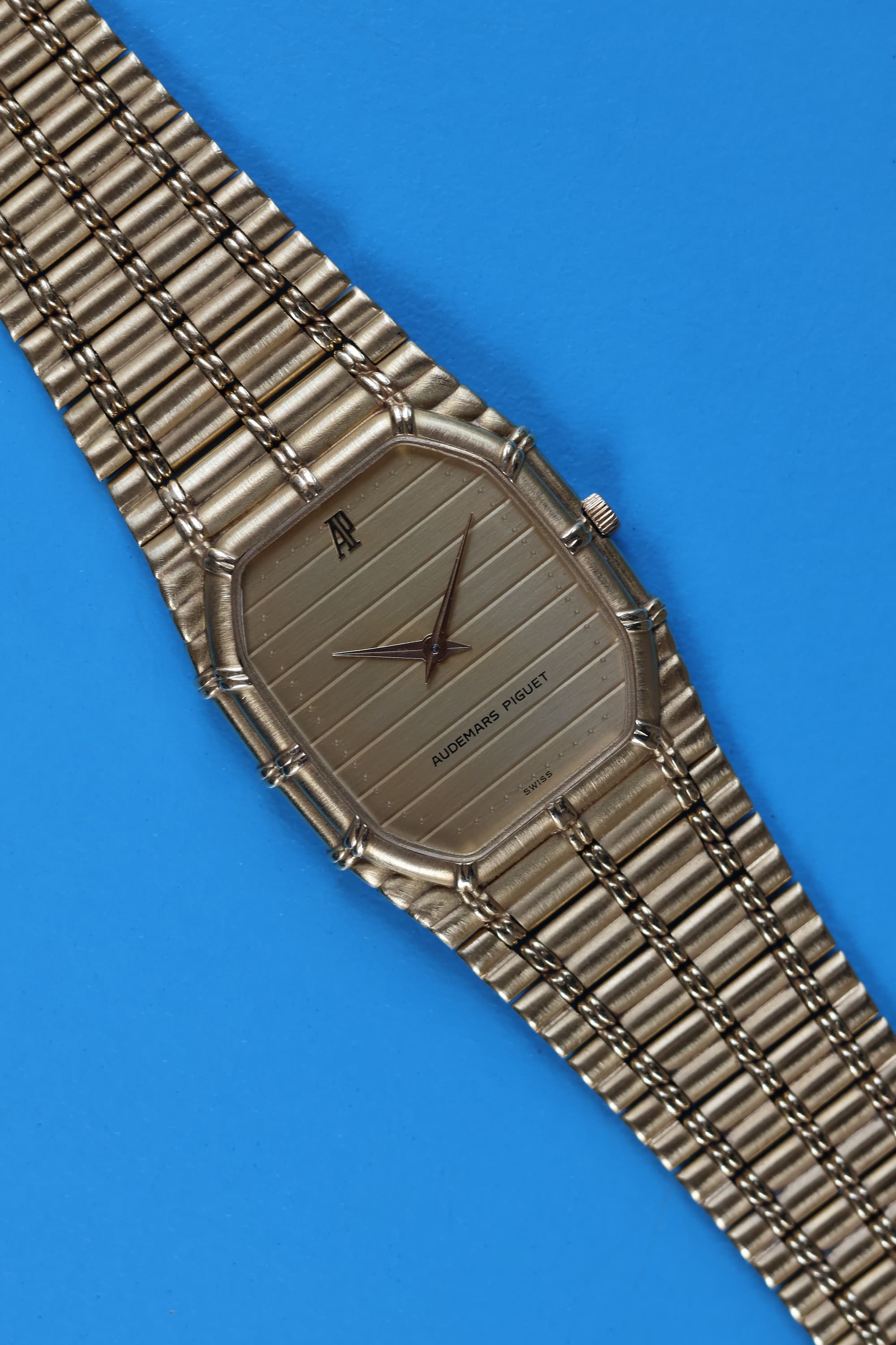 Ribbed gold-tone dial of Audemars Piguet Bamboo watch reflecting light in soft vertical wave