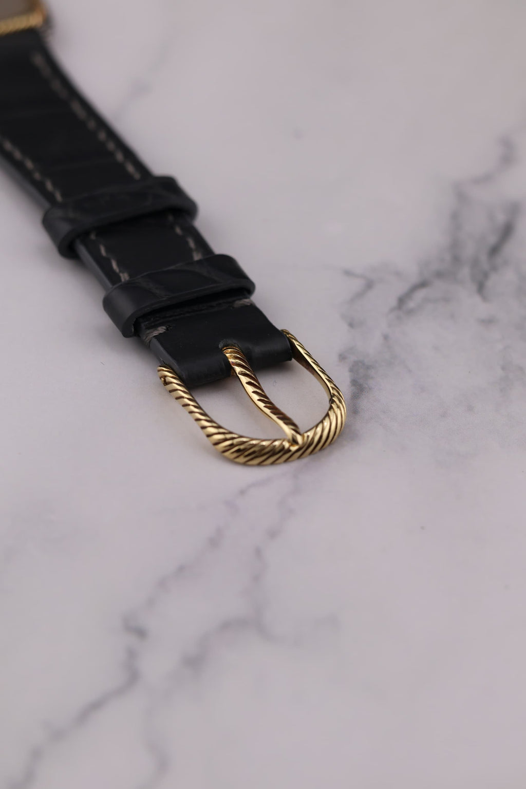 Top view of original 18K yellow gold Audemars Piguet buckle with braided motif matching watch bezel