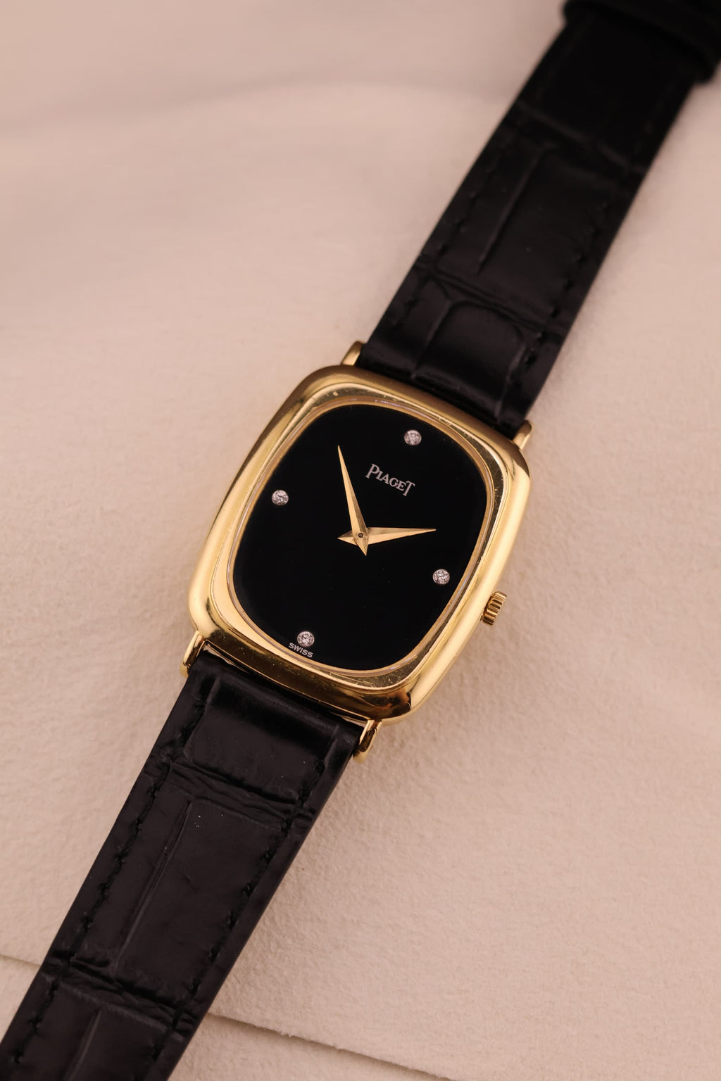 Alternate front angle of Piaget watch showcasing the sleek onyx dial and polished gold case.
