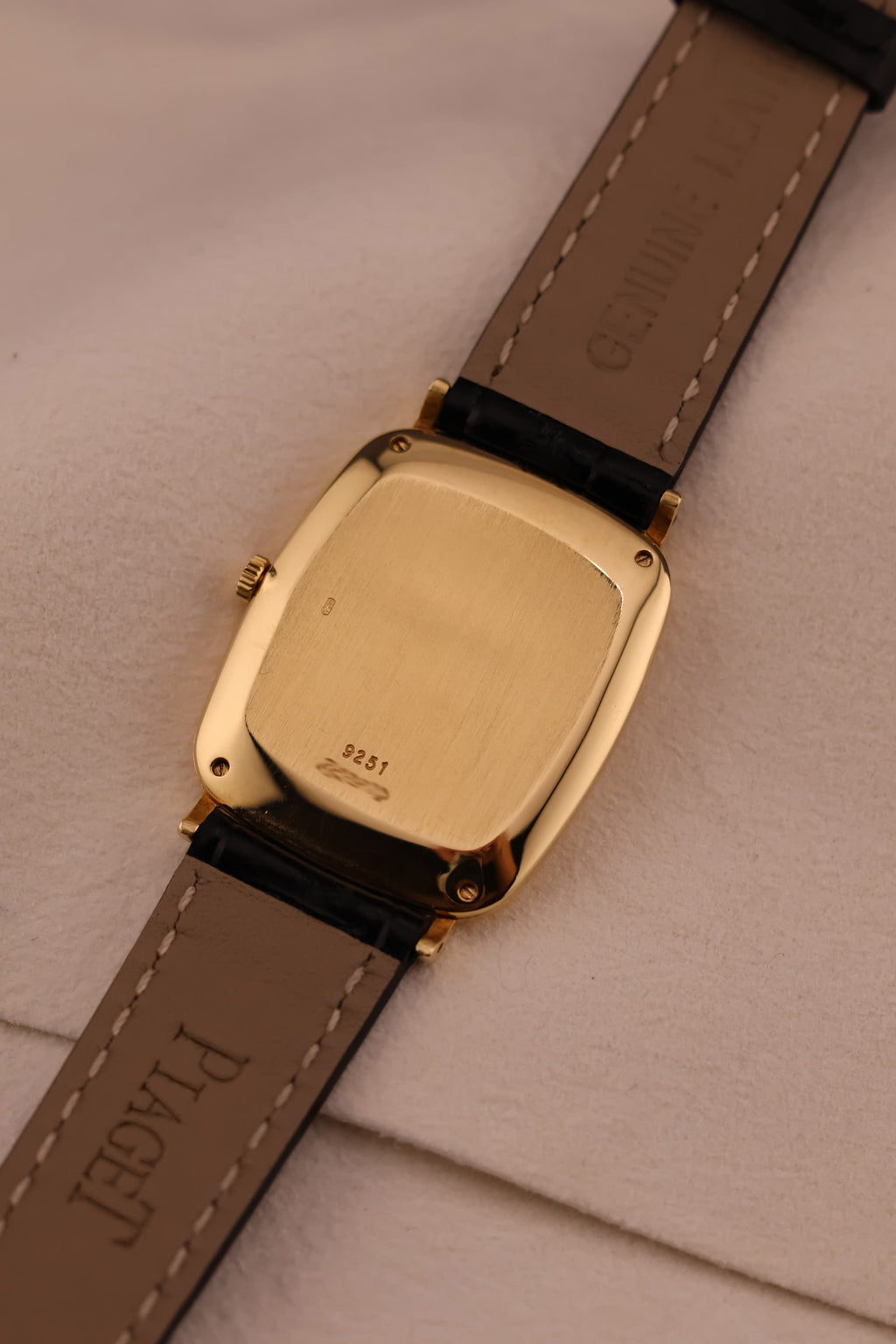 Rear view of the Piaget watch showing the solid gold caseback with hallmarks and minimal wear.