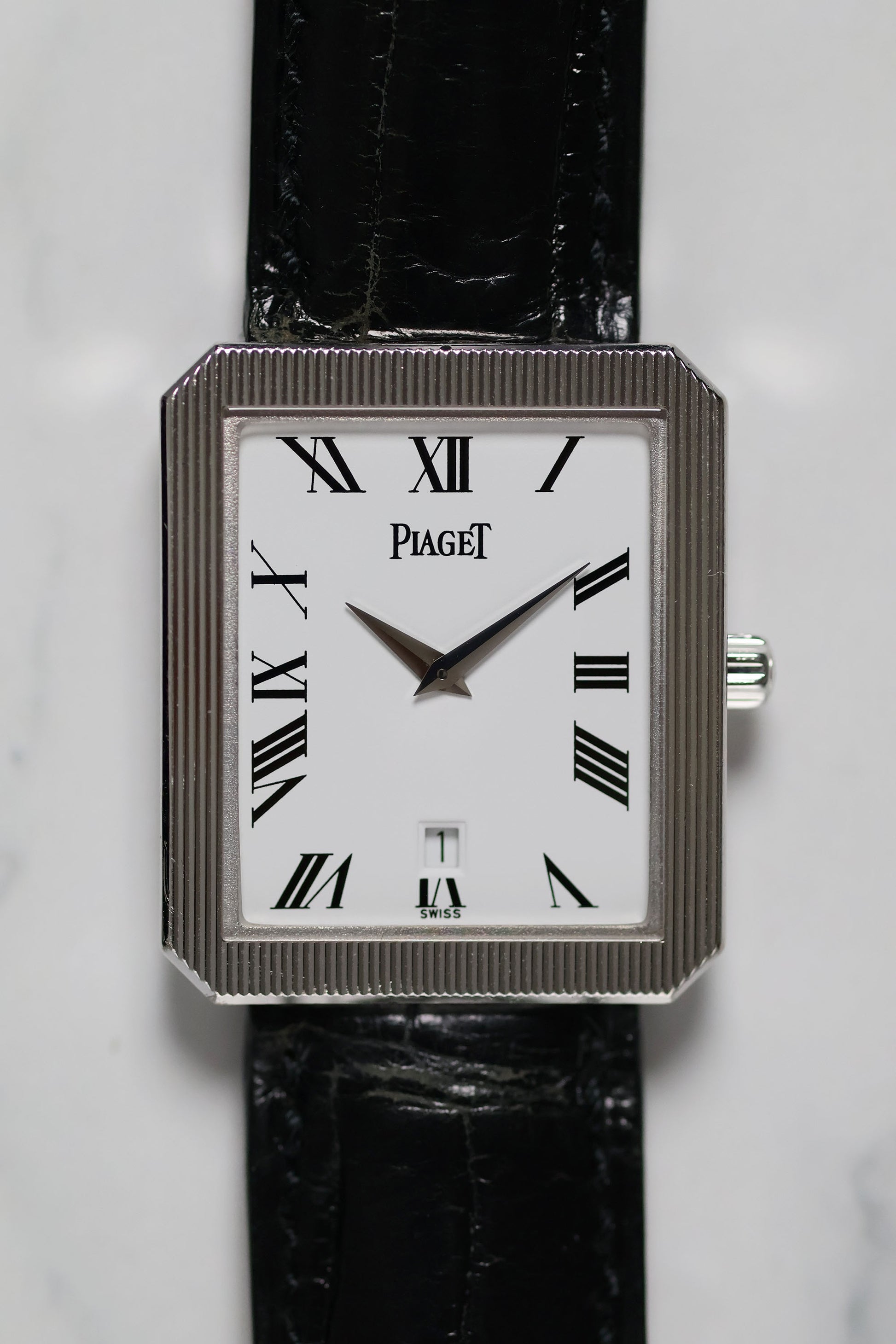 Close-up of Piaget Ref. 26354 dial featuring white background, black Roman numerals, and date window at 6 o’clock.