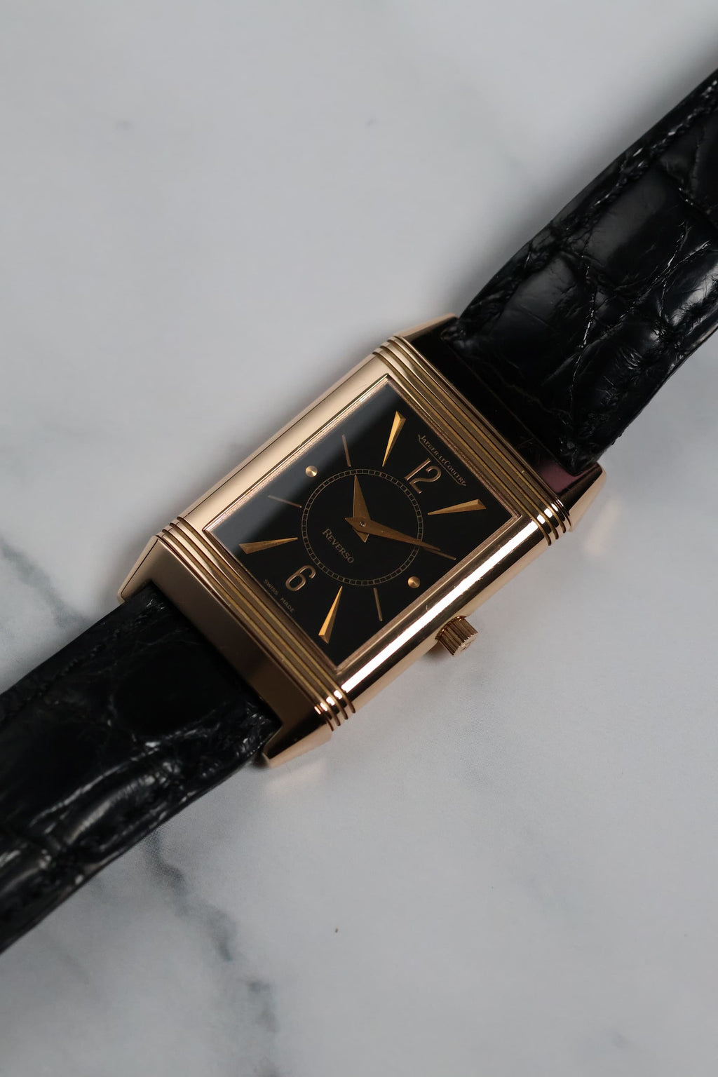 Angled shot of the Jaeger-LeCoultre Reverso highlighting the black dial and rose gold case.