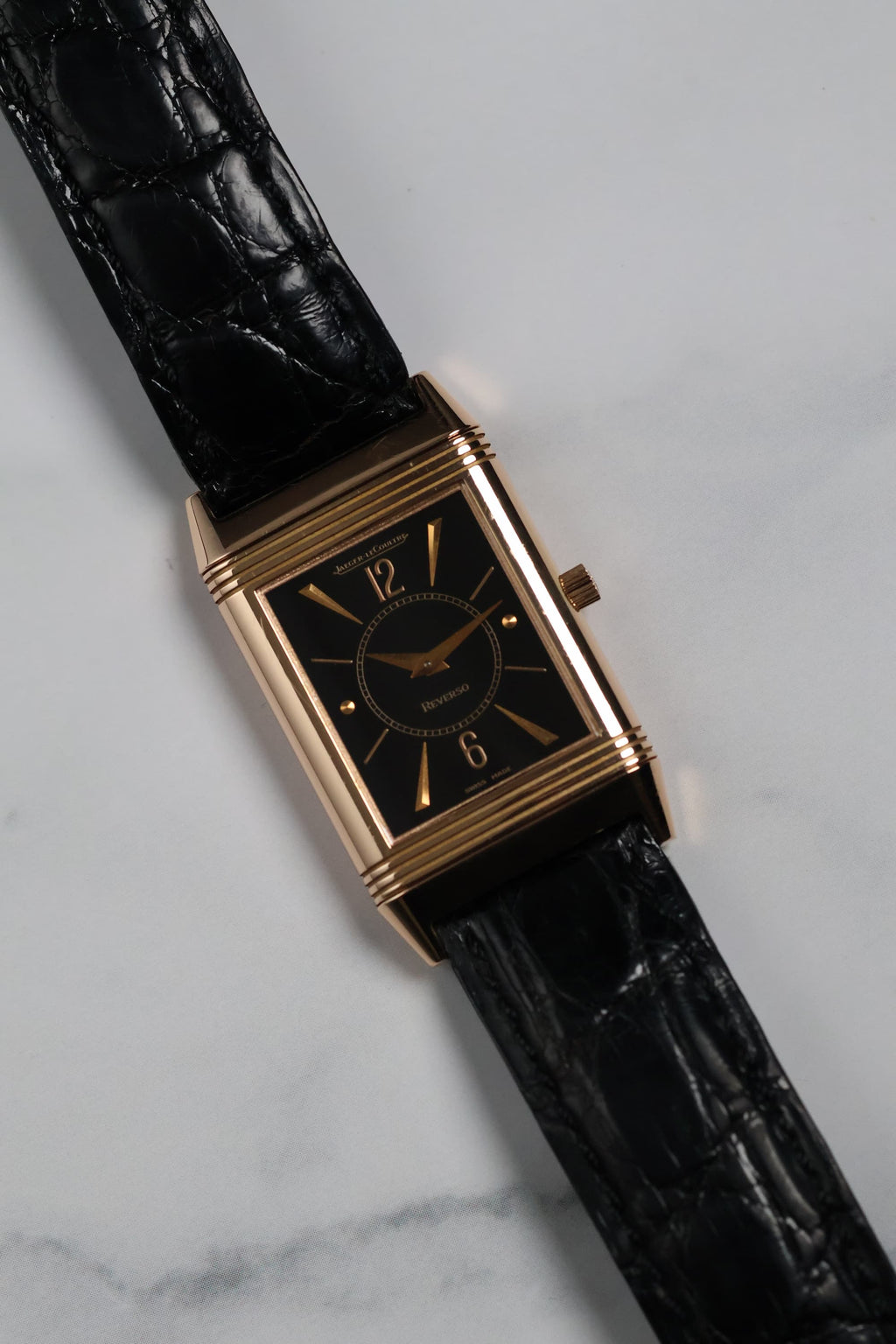 Lifestyle shot of the Reverso watch with vintage background, showing elegant proportions.