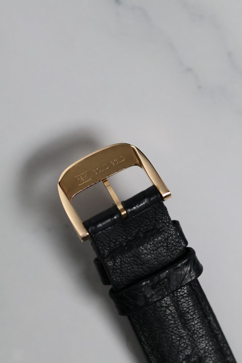 Underside of the Reverso’s 18K rose gold buckle showing hallmarks and original clasp mechanism.