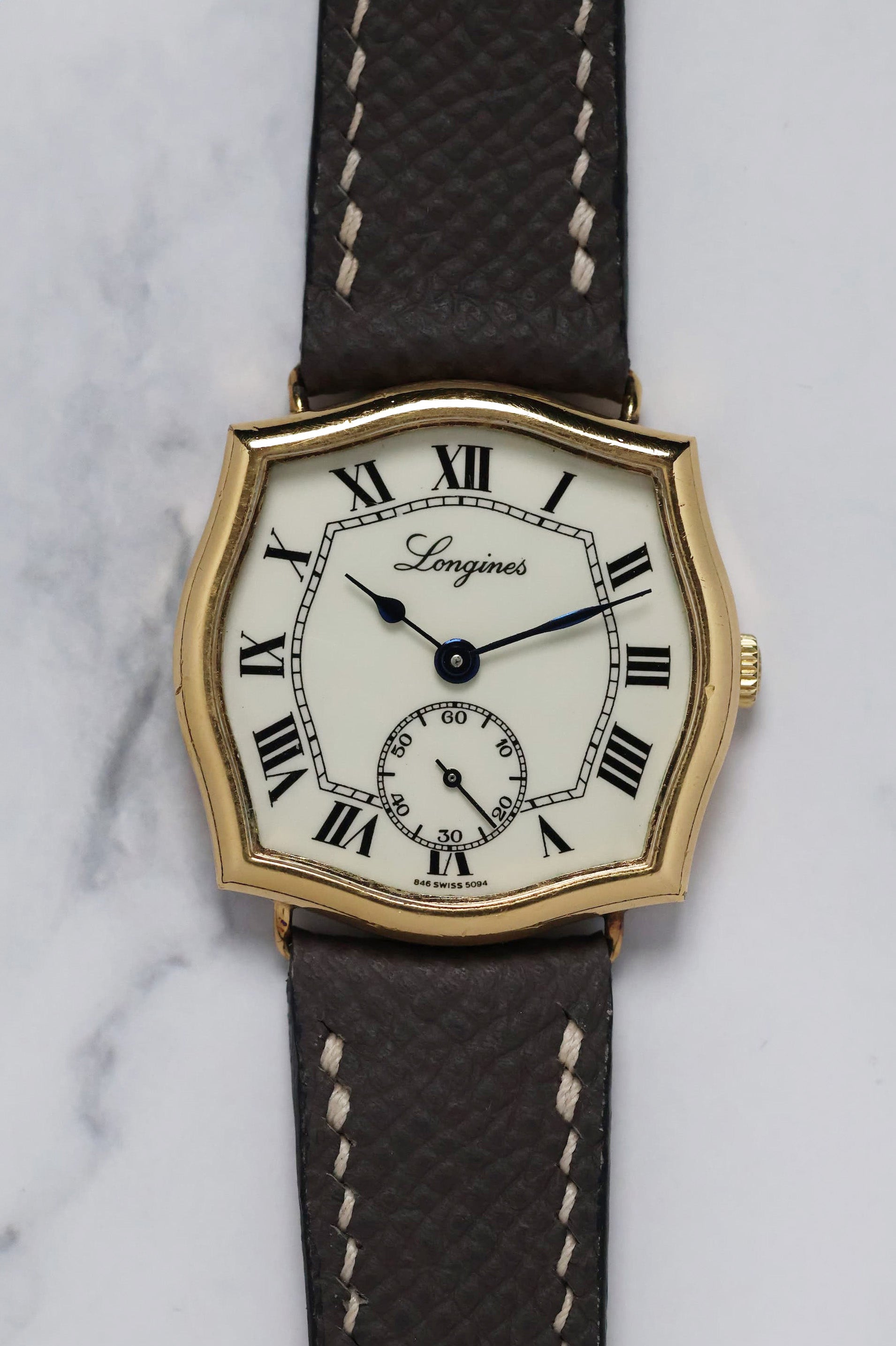 Front view of the 1970s Longines watch with distinctive Sympathie-style gold-plated case and Roman numeral dial.