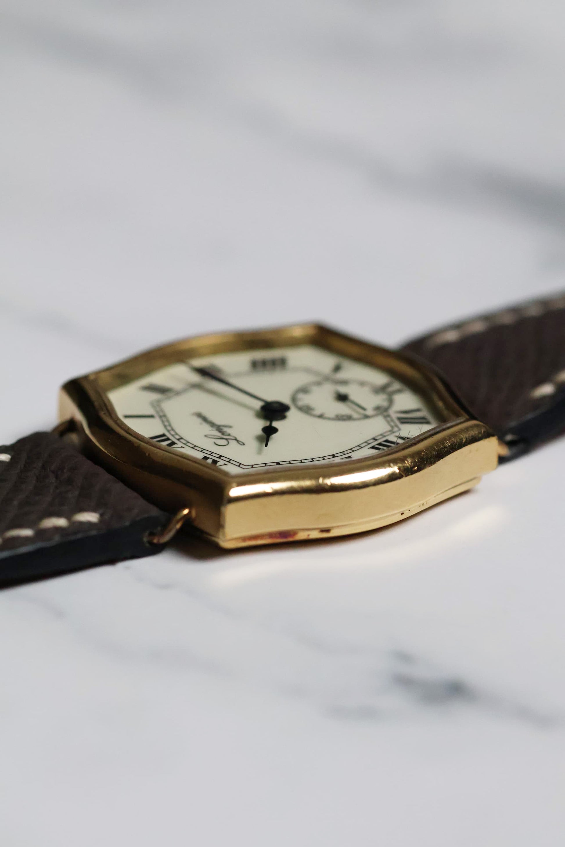 Profile view of the Longines watch showing the unique case curvature and acrylic crystal dome.