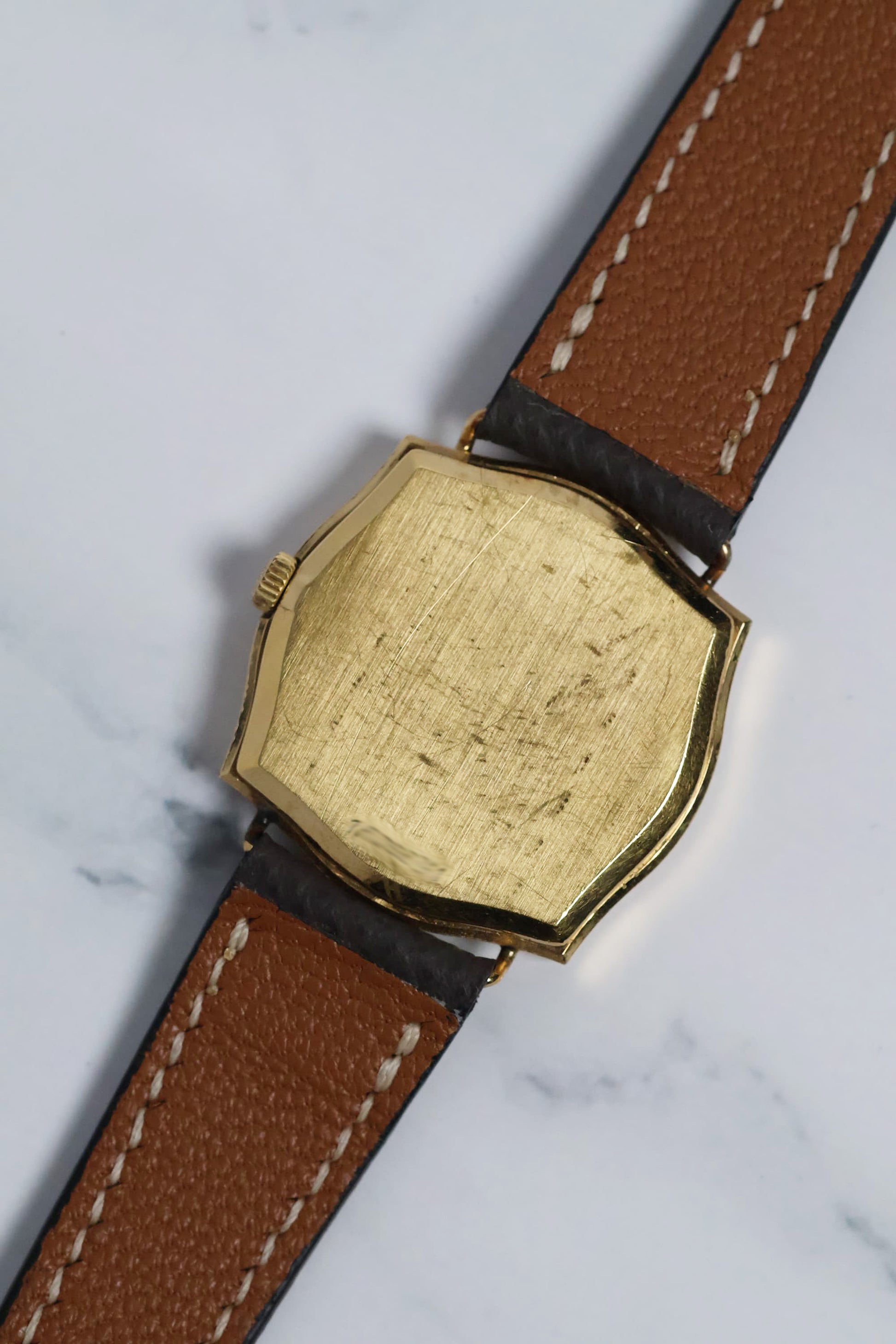 Rear view of the gold-plated caseback with vintage patina, showcasing the watch’s clean and classic design.