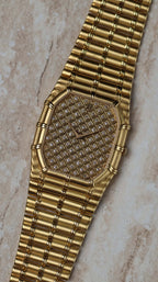 Close-up of Audemars Piguet Bamboo 27mm showcasing the full pavé diamond dial and bamboo-style gold case.