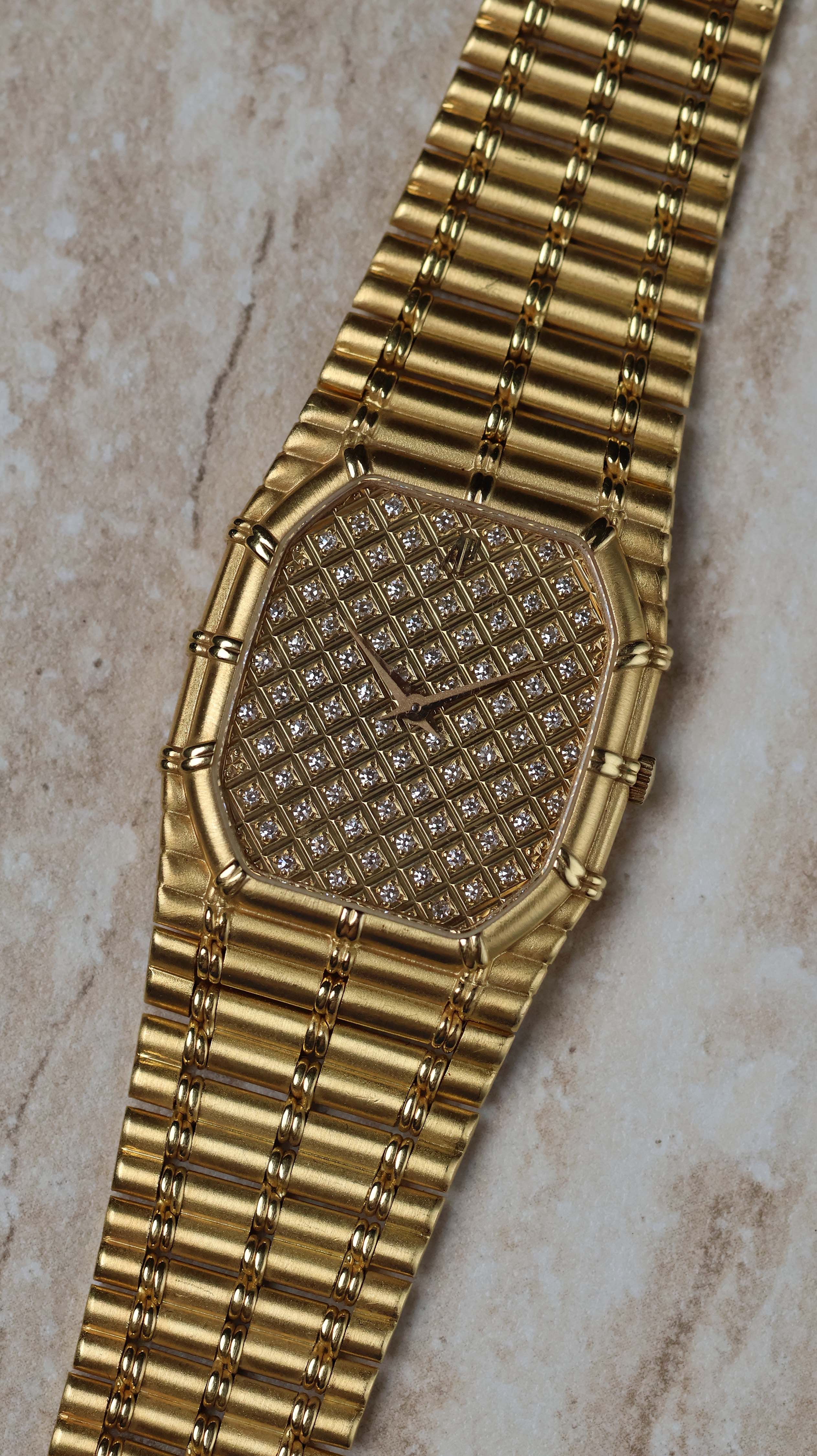 Close-up of Audemars Piguet Bamboo 27mm showcasing the full pavé diamond dial and bamboo-style gold case.