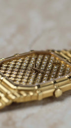 Side profile of Audemars Piguet Bamboo 27mm highlighting the signed crown and bamboo-textured case.