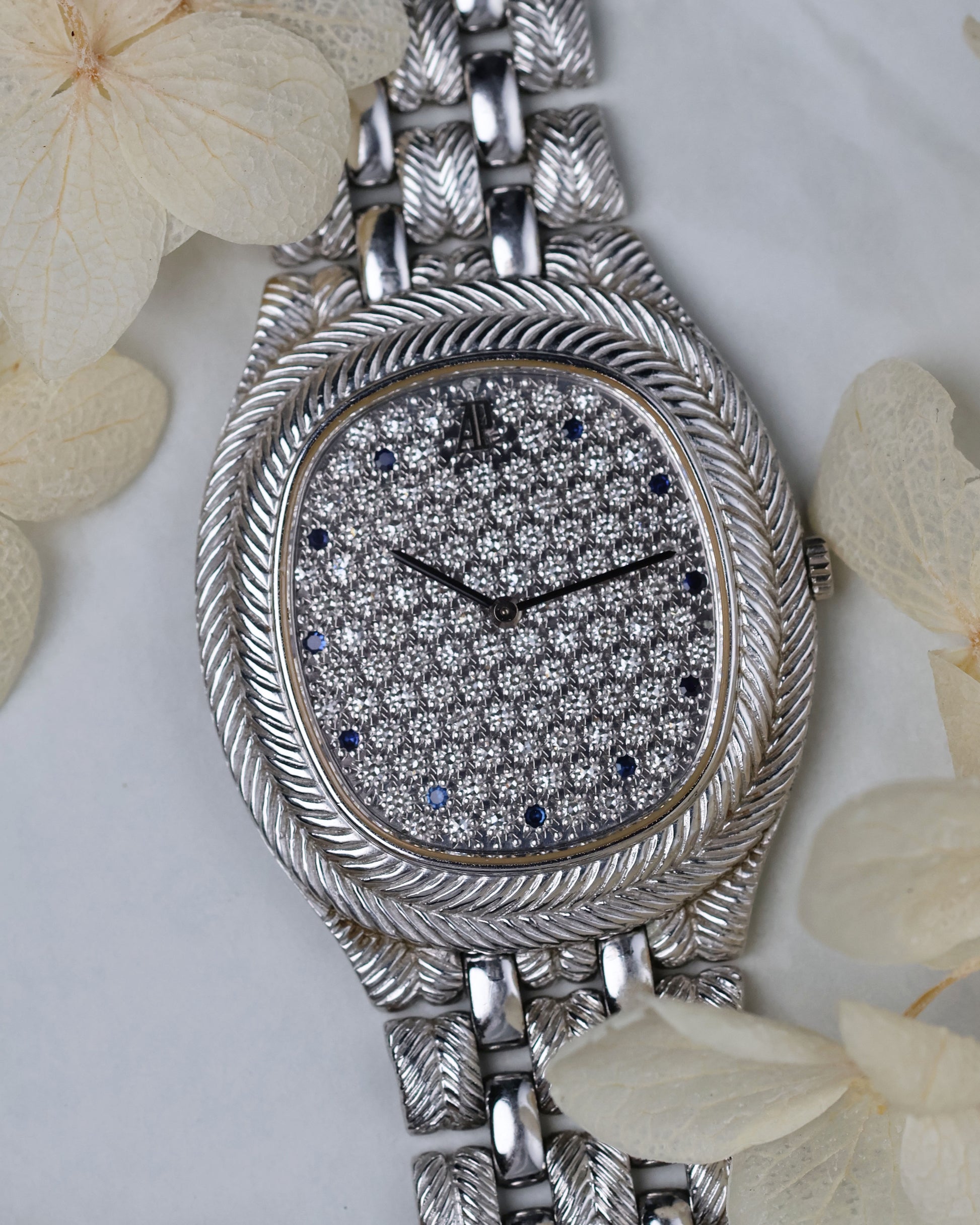 Angled shot highlighting the engraved white gold bracelet and slim profile of the Audemars Piguet Feather.