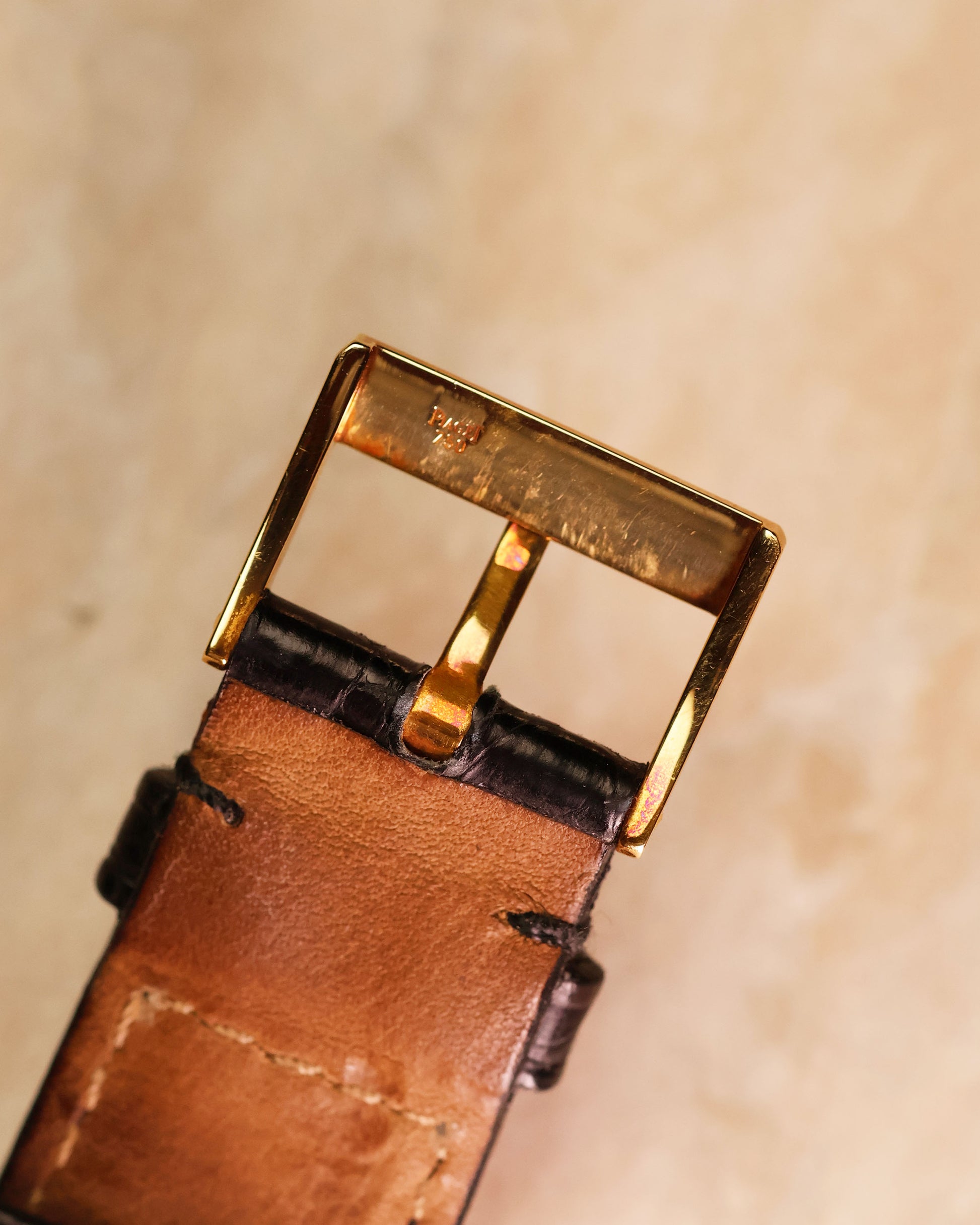 Original 18K yellow gold Piaget buckle, underside view with hallmark.