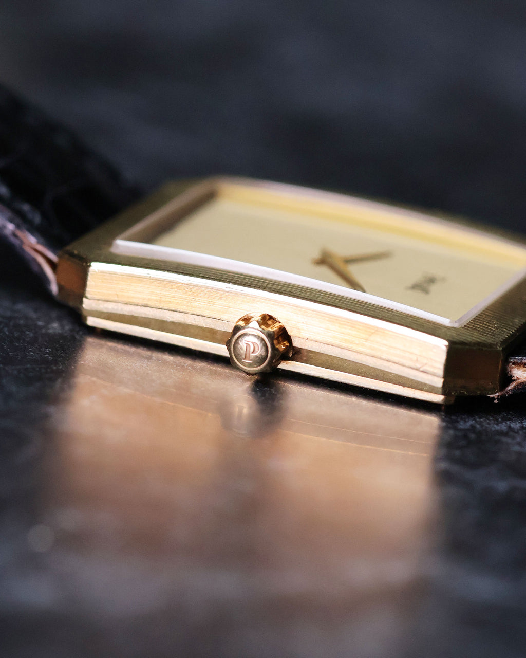 Close-up of 18K yellow gold crown on Piaget Protocole 90154, highlighting case fluting detail.