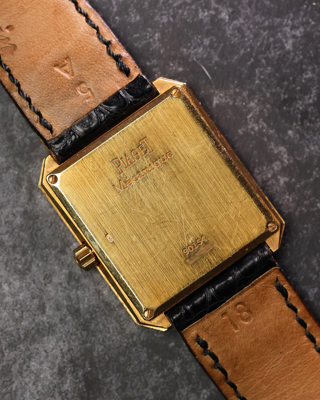 Caseback of Piaget Protocole 90154 in solid 18K yellow gold, showcasing vintage finish.