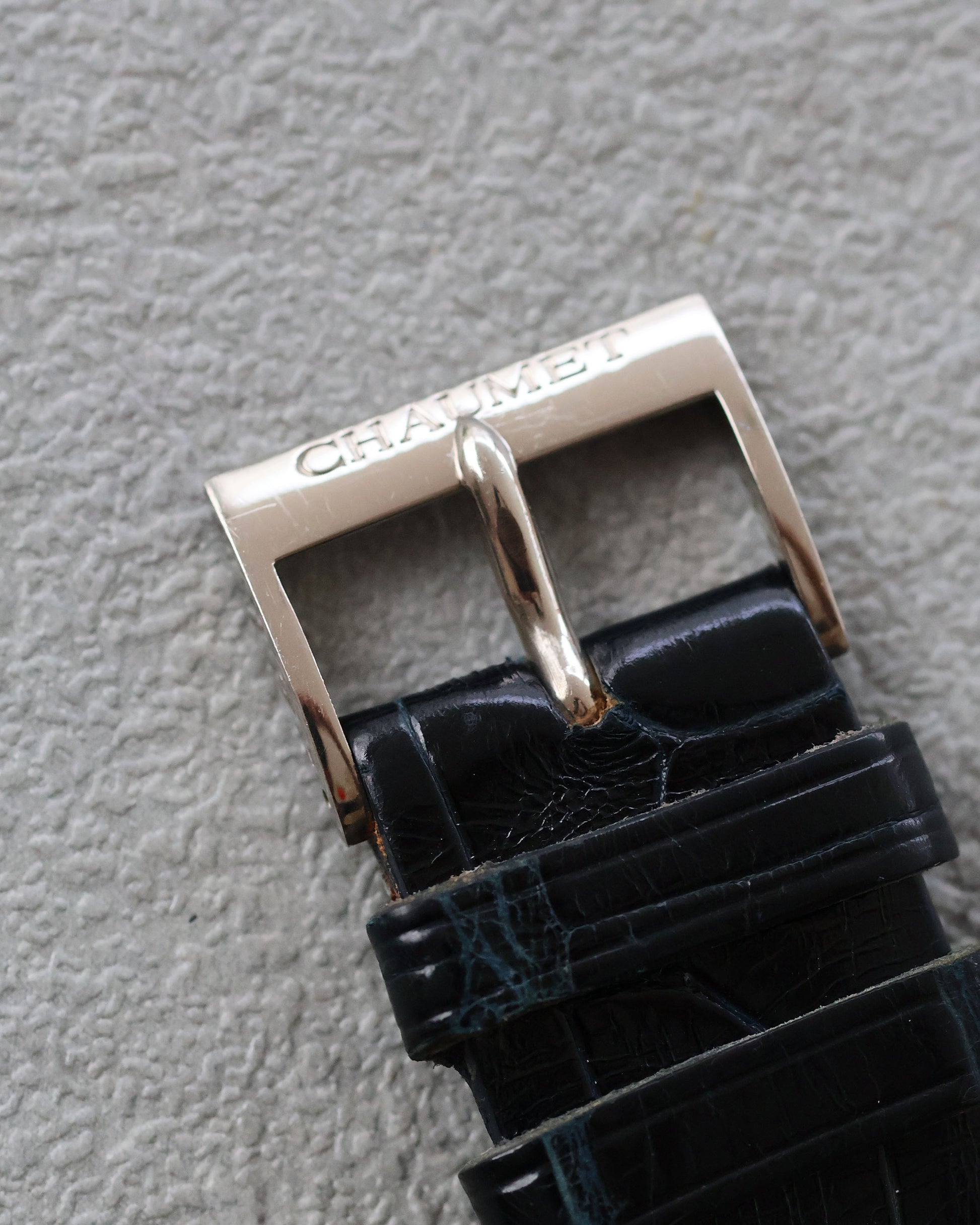 Original Chaumet 18K white gold buckle, top view on alligator strap.