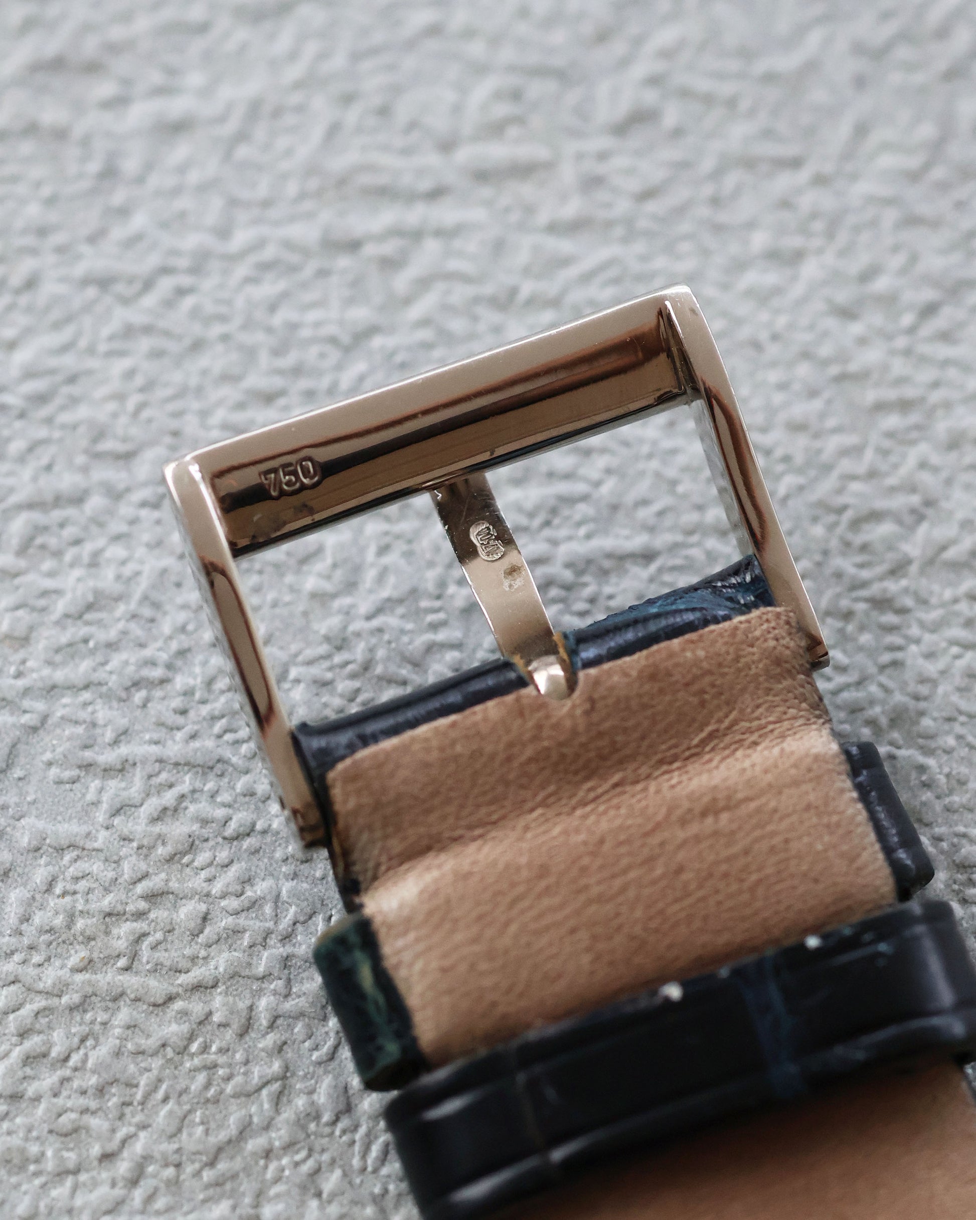 Chaumet white gold buckle underside with hallmark, attached to strap.