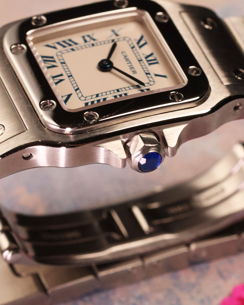 Cartier Santos Galbée Ref. 1565 close-up of crown with signature blue cabochon