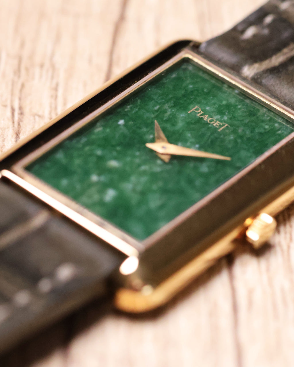 Close-up of Piaget jade dial showing natural stone texture and gold baton hands