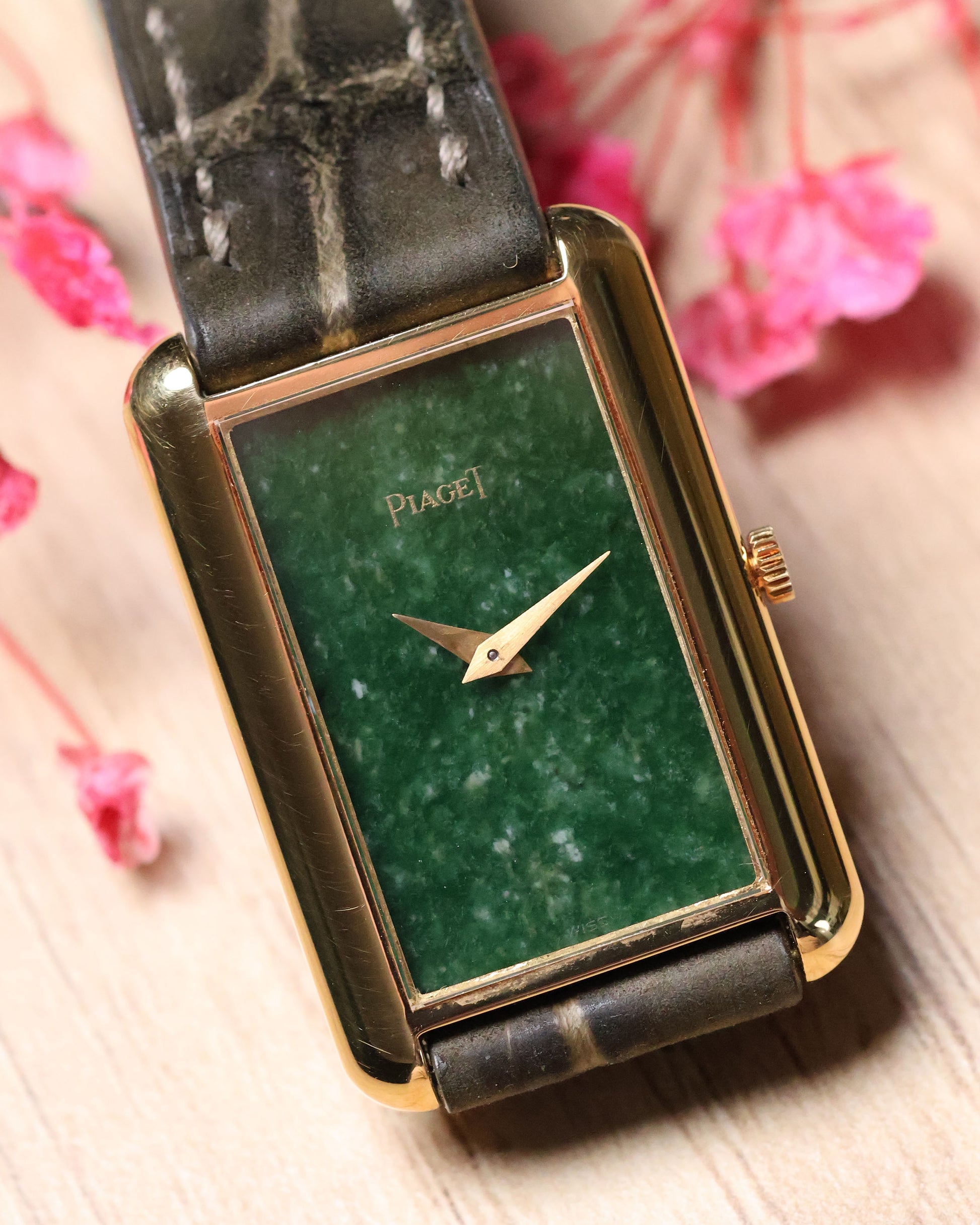 Piaget Ref. 9228 rectangular gold watch with jade stone dial, displayed on stand