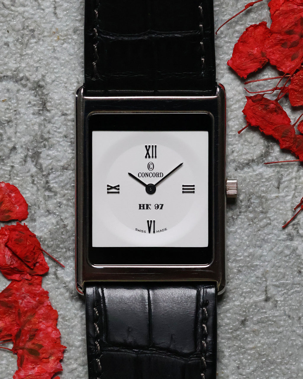 Angled shot of the Concord Delirium HK 97 Limited Edition showcasing its slim 4.1mm platinum profile on black alligator strap.