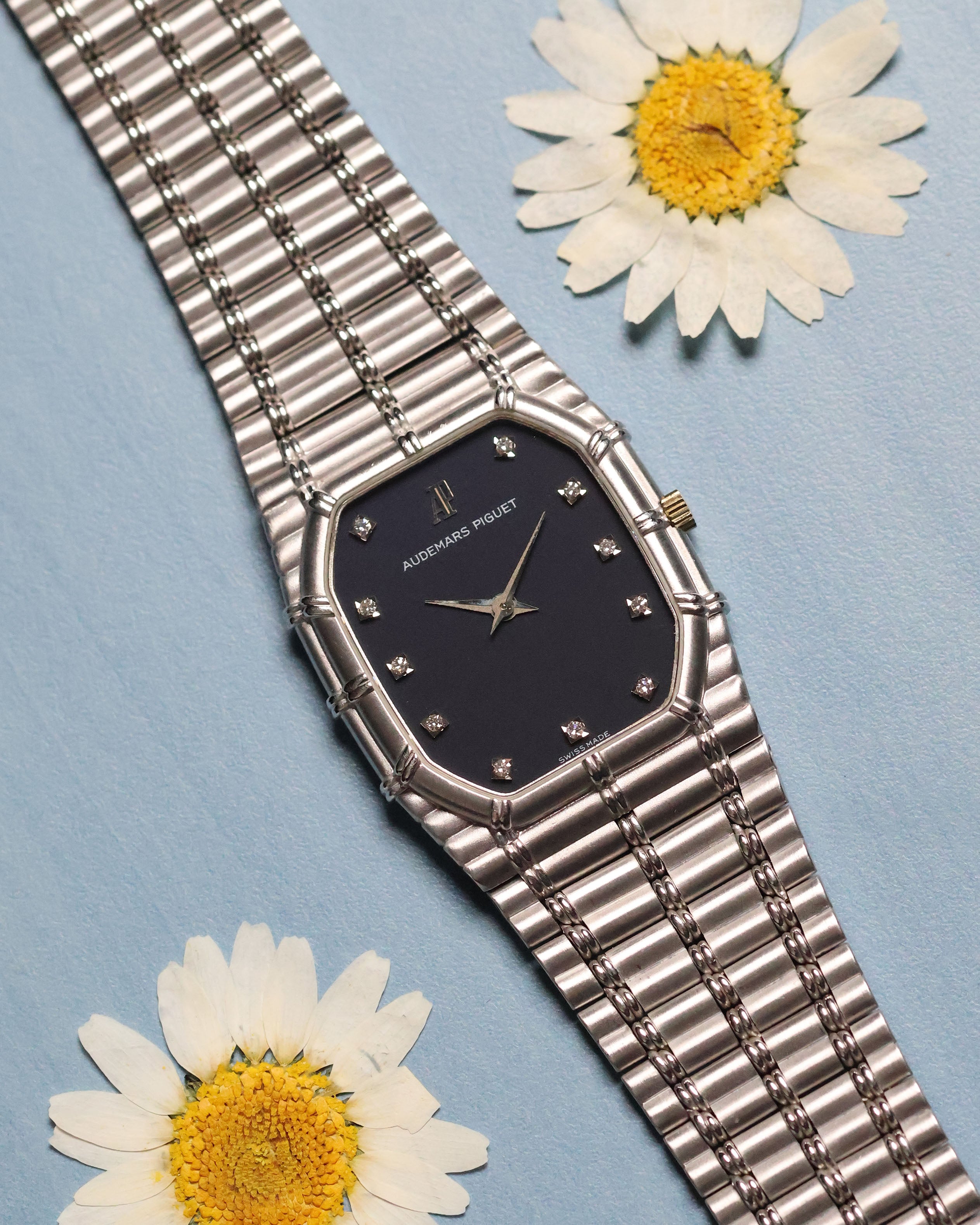 Audemars Piguet Bamboo 27mm in 18k white gold with dark blue matte dial and diamond hour markers, full view on integrated bracelet