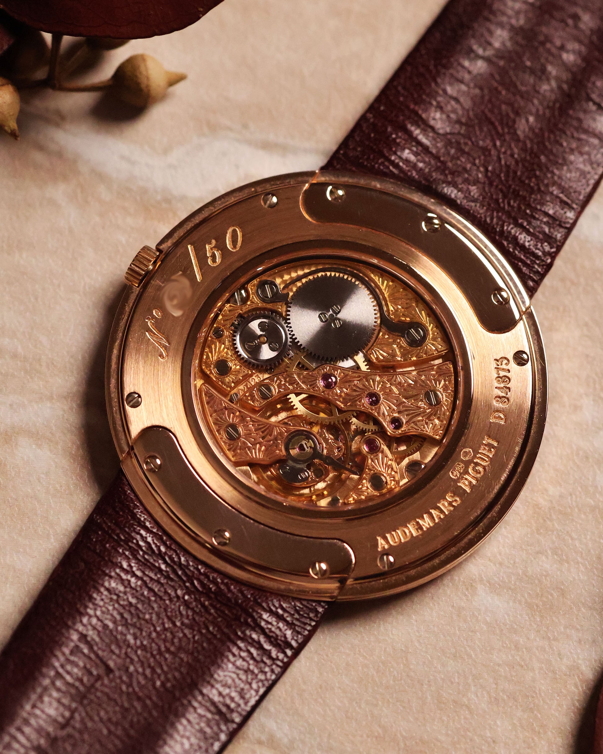 Open caseback view of Audemars Piguet Disco Volante 14988OR showing hand-engraved manual-winding movement