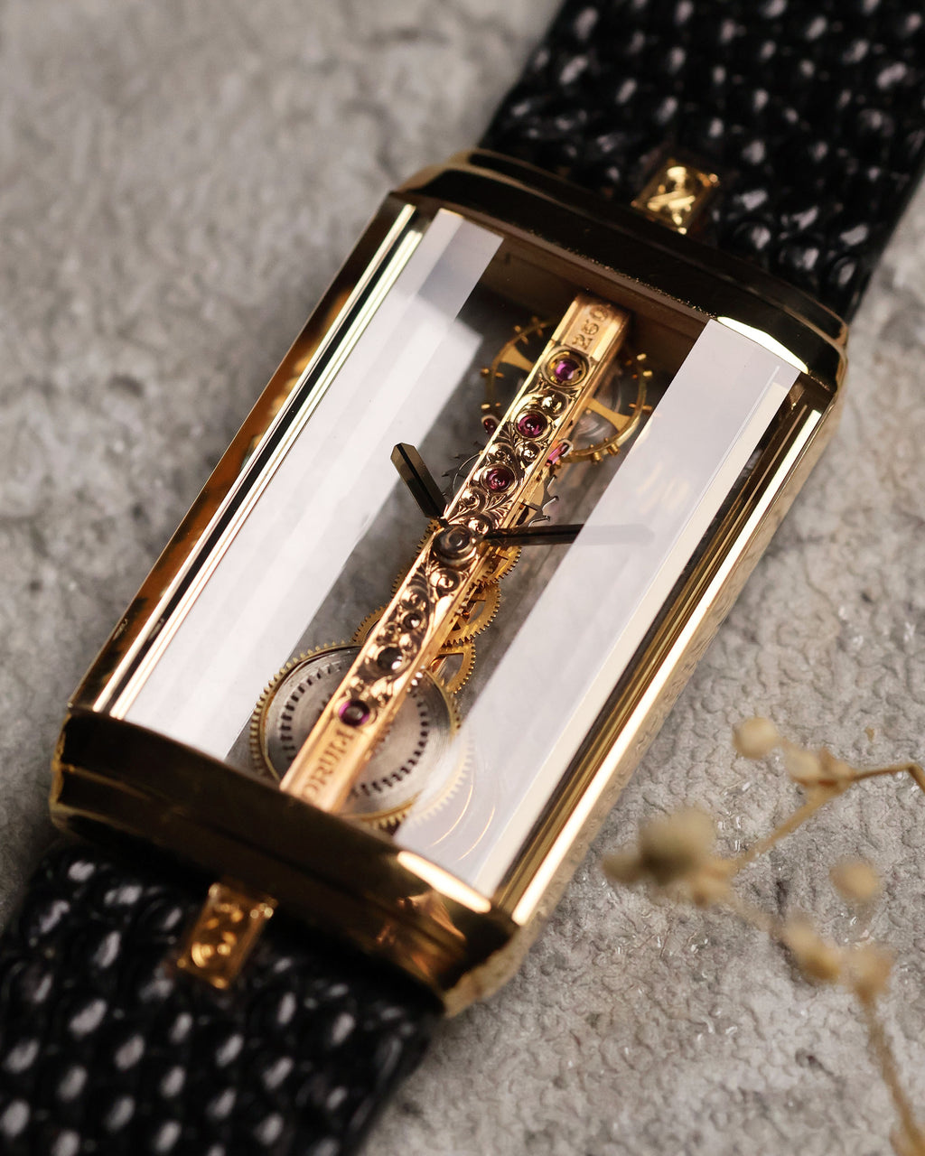 Angled front shot of the Corum Golden Bridge 13150, emphasizing the depth of the transparent case and the vertical alignment of the linear skeleton movement with engraved bridge.