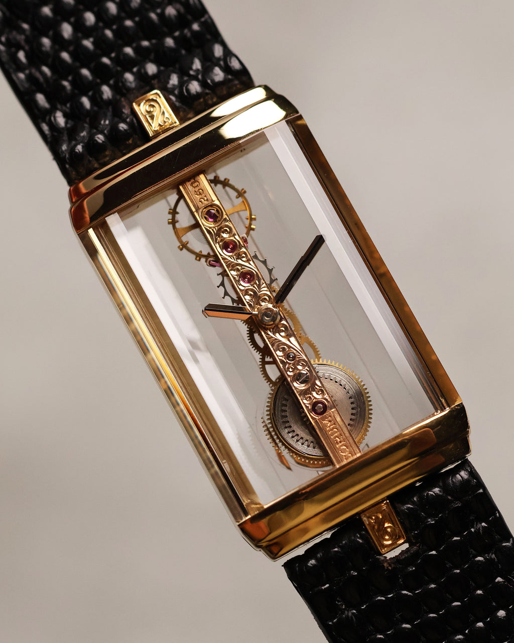 Front shot of the Corum Golden Bridge 13150, capturing the full skeletonized movement suspended within the sapphire case and the engraved bridge with visible ruby settings.