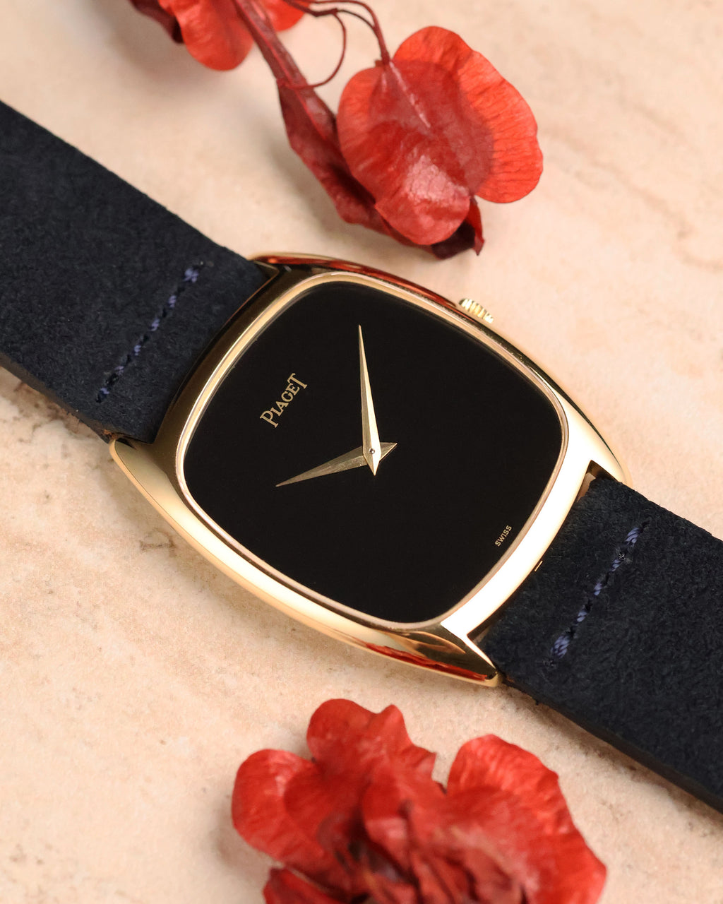 Piaget 9591 photographed at an angle, highlighting the glossy dial surface and slim case profile with suede strap.