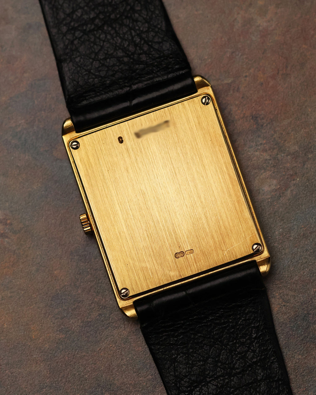 Caseback of Audemars Piguet Skeleton Aperture Tank showing brushed gold surface and hallmarks.