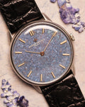 Close-up of the Vacheron Constantin Ref. 2006 showing the titanium blue mosaic dial, gold baton hands, and indices under soft natural light.
