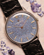 Close-up of the Vacheron Constantin Ref. 2006 showing the titanium blue mosaic dial, gold baton hands, and indices under soft natural light.