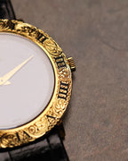 Macro detail of the Piaget 9118’s engraved gold bezel and crown, highlighting the carved Roman numerals and decorative scrollwork.