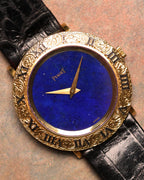 Straight-on shot of the Piaget 9118 featuring its deep lapis lazuli dial, engraved 18K gold Roman bezel, and gold hands on a black leather strap.