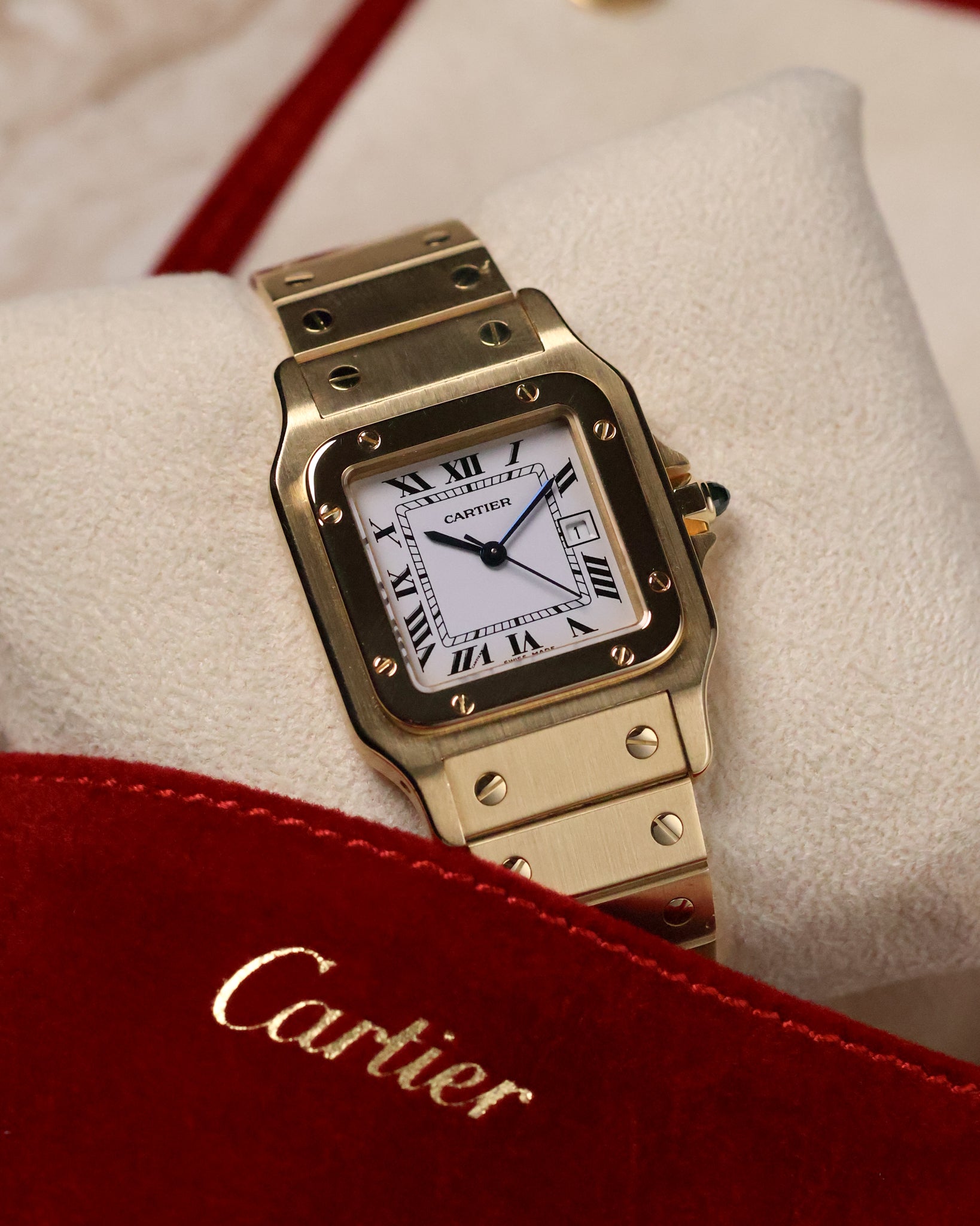 Front-facing close-up of the Cartier Santos Carrée Ref. 2960, displaying the polished gold bezel, crisp Roman numerals, blued-steel hands, and brushed gold bracelet links.