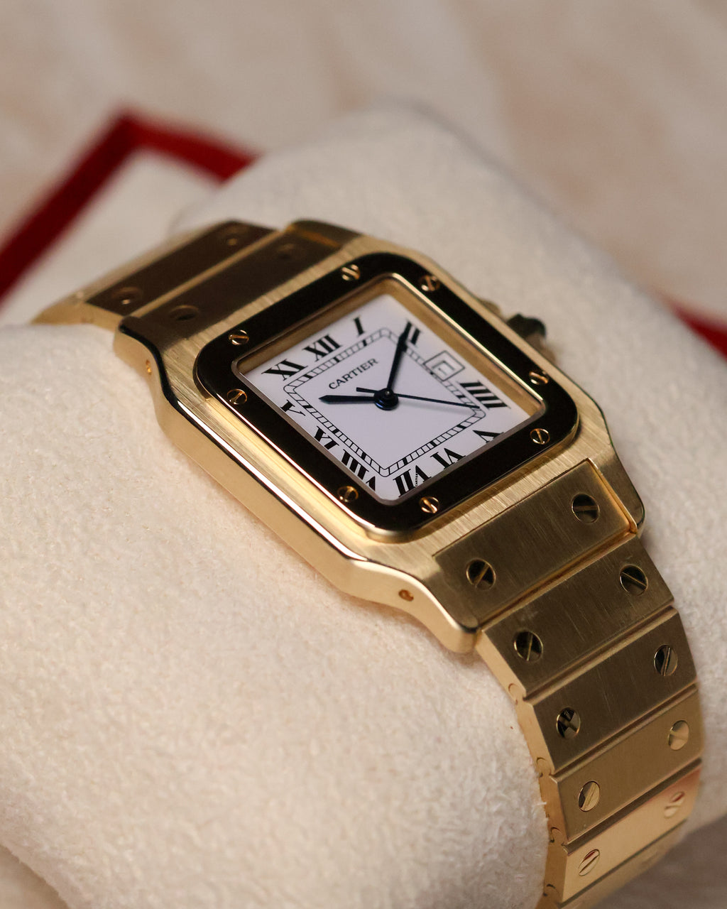 Angled view of the Cartier Santos Carrée Ref. 2960 in 18K yellow gold, highlighting the brushed and polished case surfaces and integrated gold bracelet.