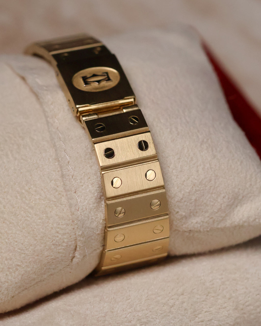 Close-up of the Cartier Santos Carrée Ref. 2960 bracelet clasp in 18K yellow gold, showing the brushed finish, signature Santos screws, and Cartier logo on the clasp.