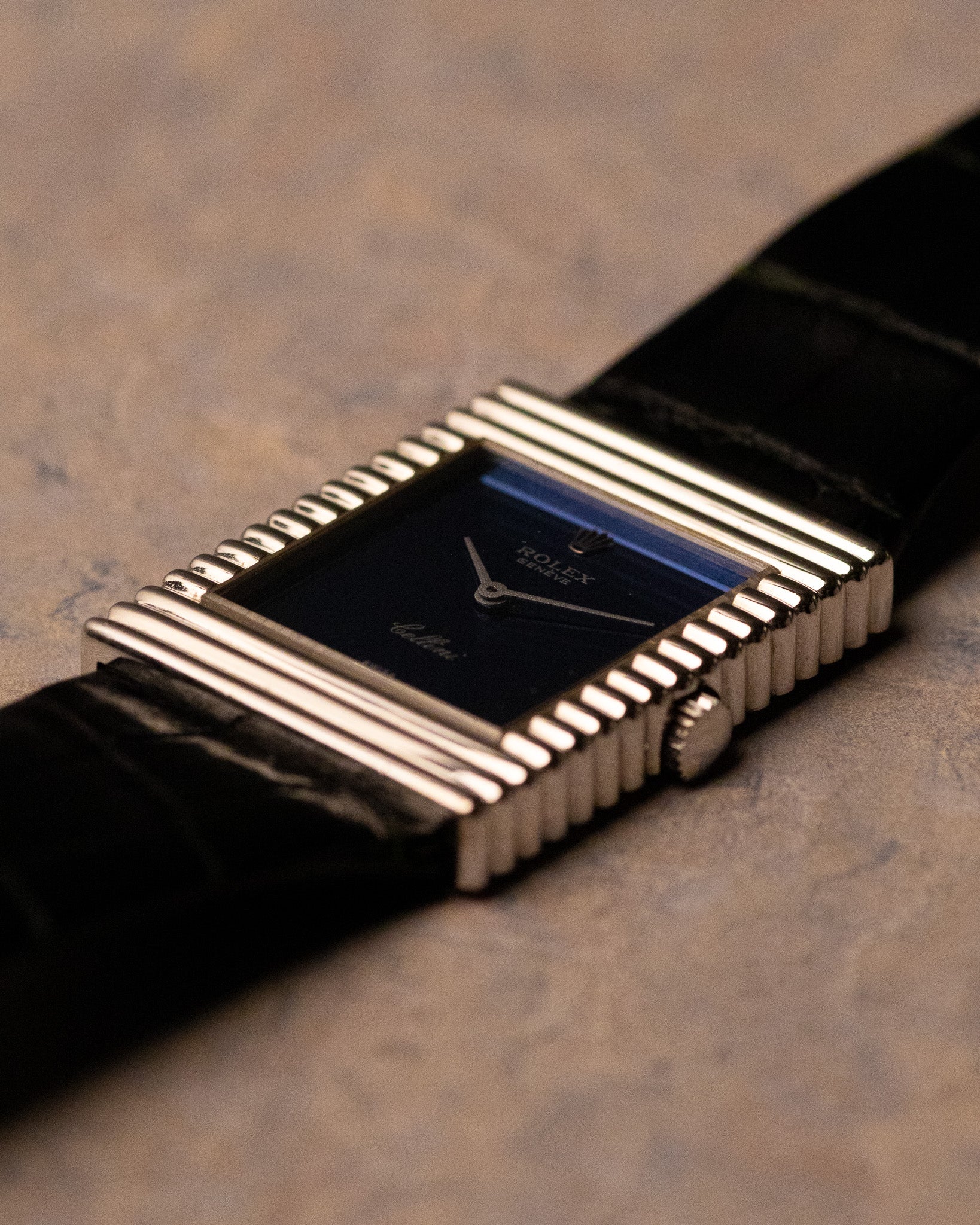 Low-angle view of Rolex Cellini 4012 blue mirror dial reflecting light, ribbed case detail