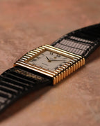 Three-quarter low-angle view of a Rolex Cellini Ref. 4015 emphasizing the layered ribbed 18K gold case and black textured leather strap.