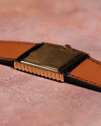 Side angle photograph of the Rolex Cellini Ref. 4015 showing the solid 18K gold caseback, ribbed case edges, and leather strap interior.