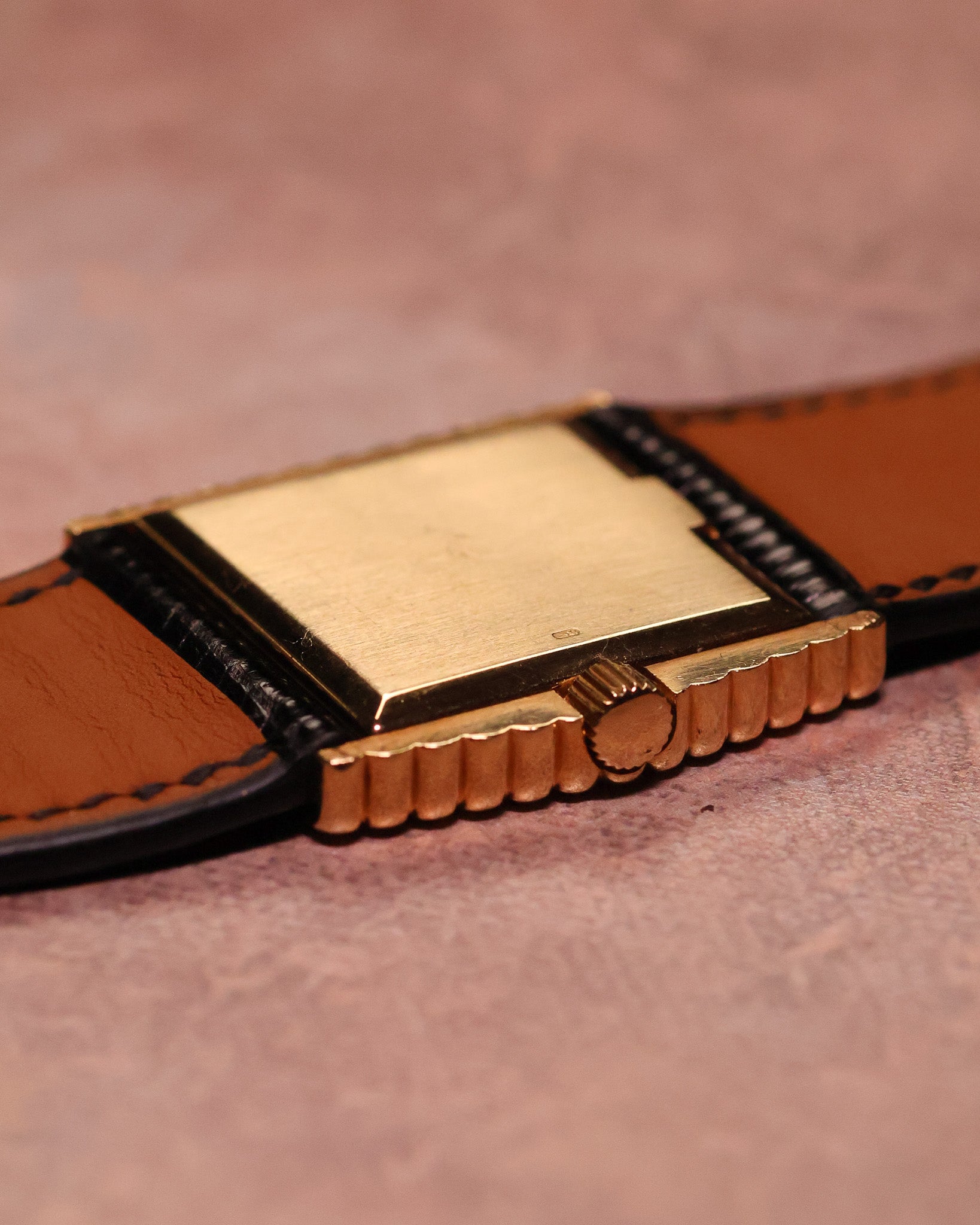 Close-up of the solid 18K yellow gold caseback on a Rolex Cellini Ref. 4015, displaying natural wear consistent with age and use.