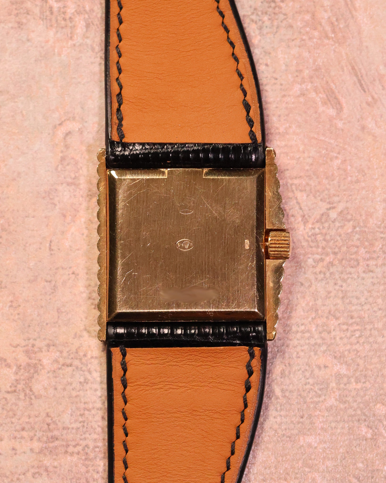 Rear view of the Rolex Cellini Ref. 4015 showing the gold caseback, signed crown, asymmetric case construction, and leather strap.