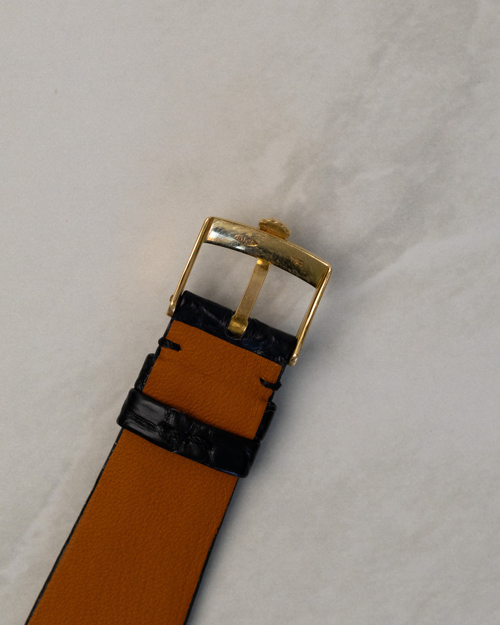 Rear view of original 18K yellow gold Rolex buckle fitted to black leather strap