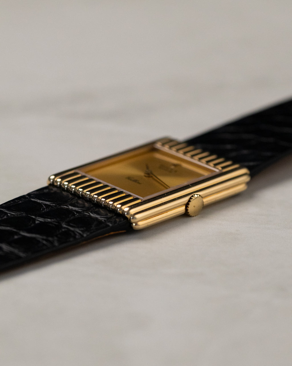 Side view of Rolex Cellini 4016 showing recessed crown integrated into rectangular gold case