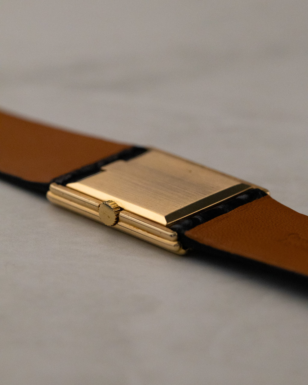 Rear angled view of Rolex Cellini 4016 showing polished gold caseback and stepped rectangular case construction