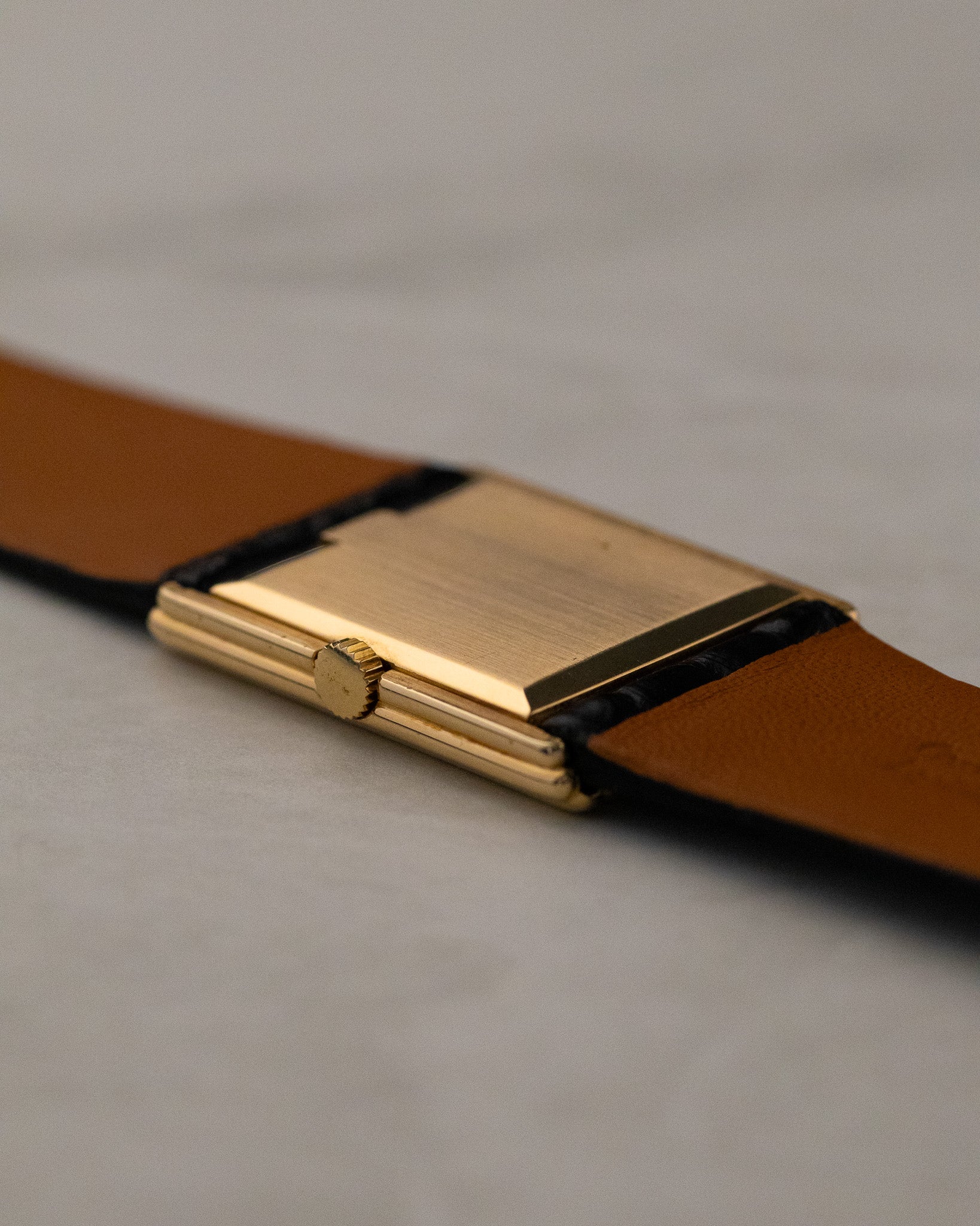Rear angled view of Rolex Cellini 4016 showing polished gold caseback and stepped rectangular case construction