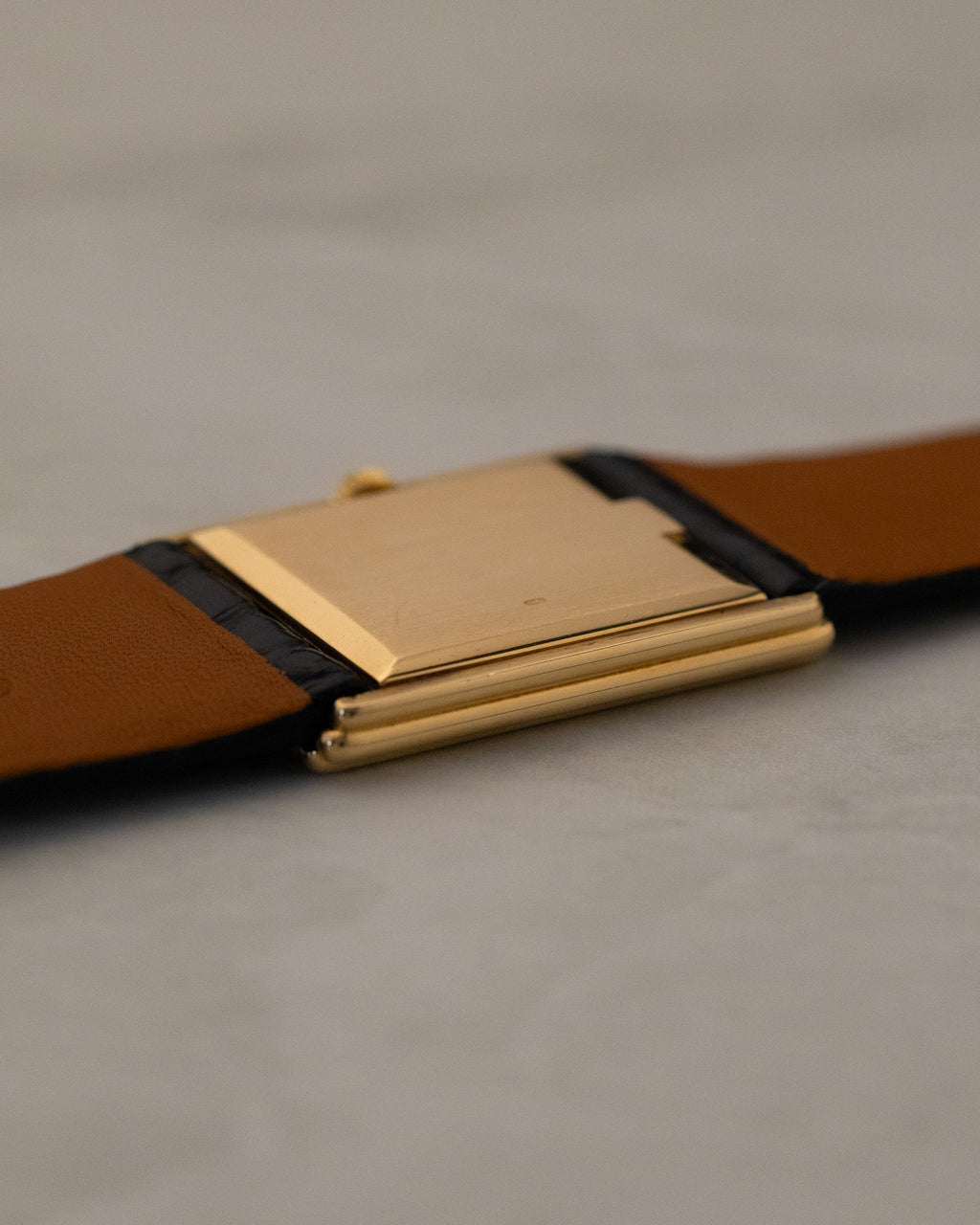 Rear low-angle view of Rolex Cellini 4016 showing brushed gold caseback surface and slim rectangular profile